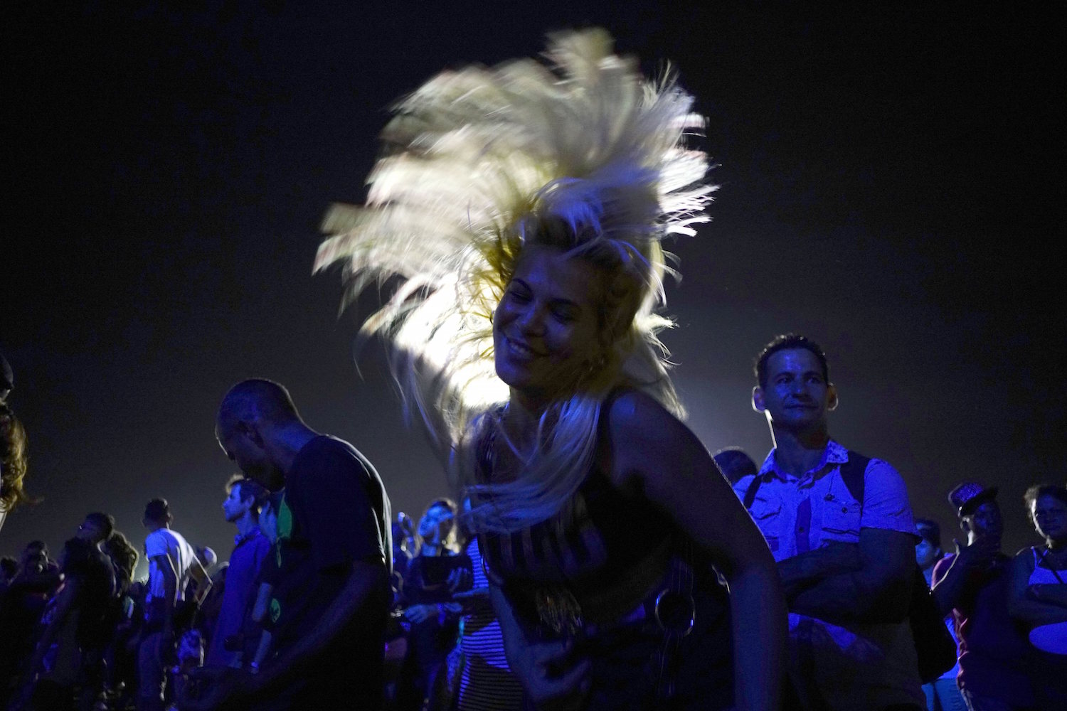 People dance at a Rolling Stones concert in Havana, Cuba, Friday March 25, 2016. (AP Photo/Ramon Espinosa)